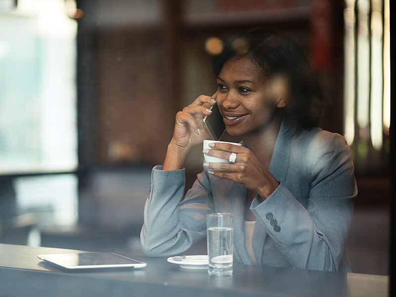 woman speaking on phone in coffee shop